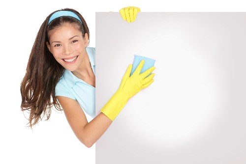 Technician performing carpet cleaning with extraction equipment