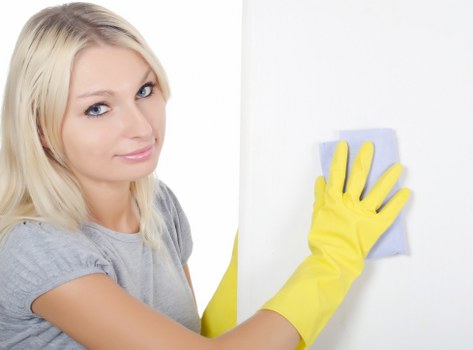 Professional cleaner maintaining shared hallway space